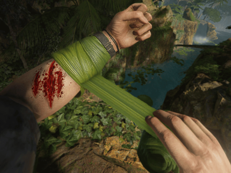 Player wrapping a bandage around their injured arm in Green Hell VR on PSVR2.