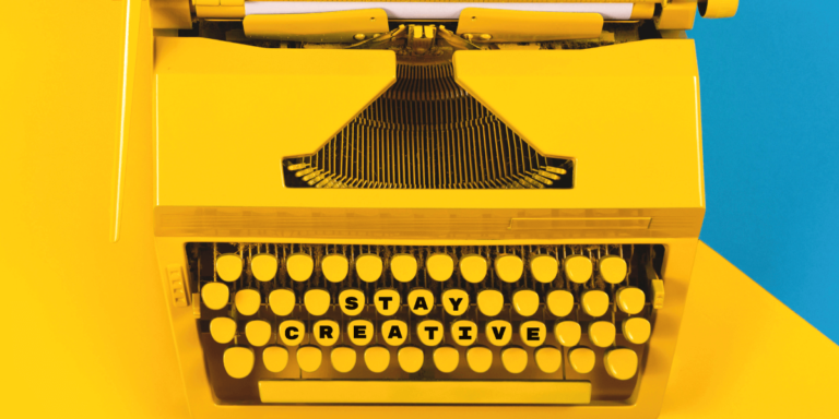 yellow typewriter saying stay creative