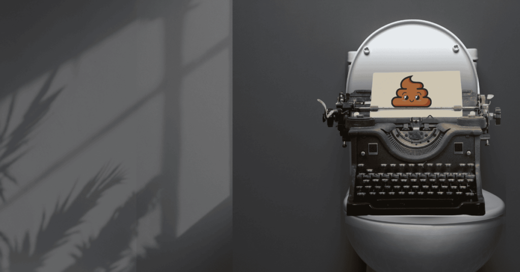 A vintage typewriter sitting on a toilet with a sheet of paper showing a cartoon poop emoji, symbolizing messy first drafts and the creative process.