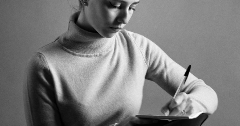 woman writing in a notebook, how to write when tired depressed or burnt out